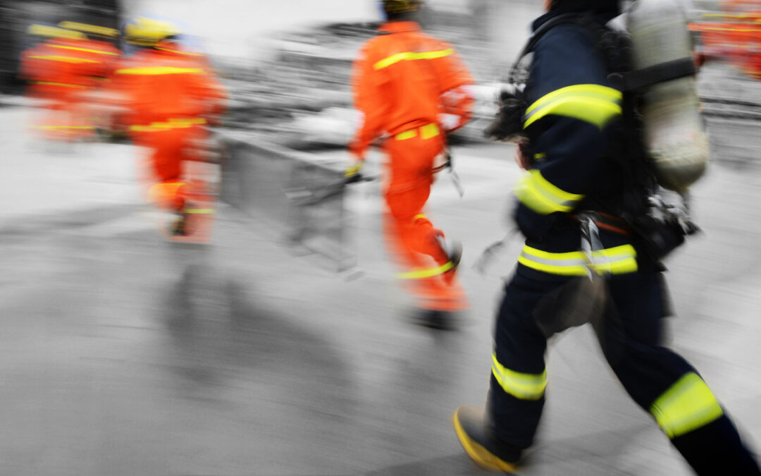 Business Resilience And Disaster Recovery - a blurry image of a group of firefighters walking on a street