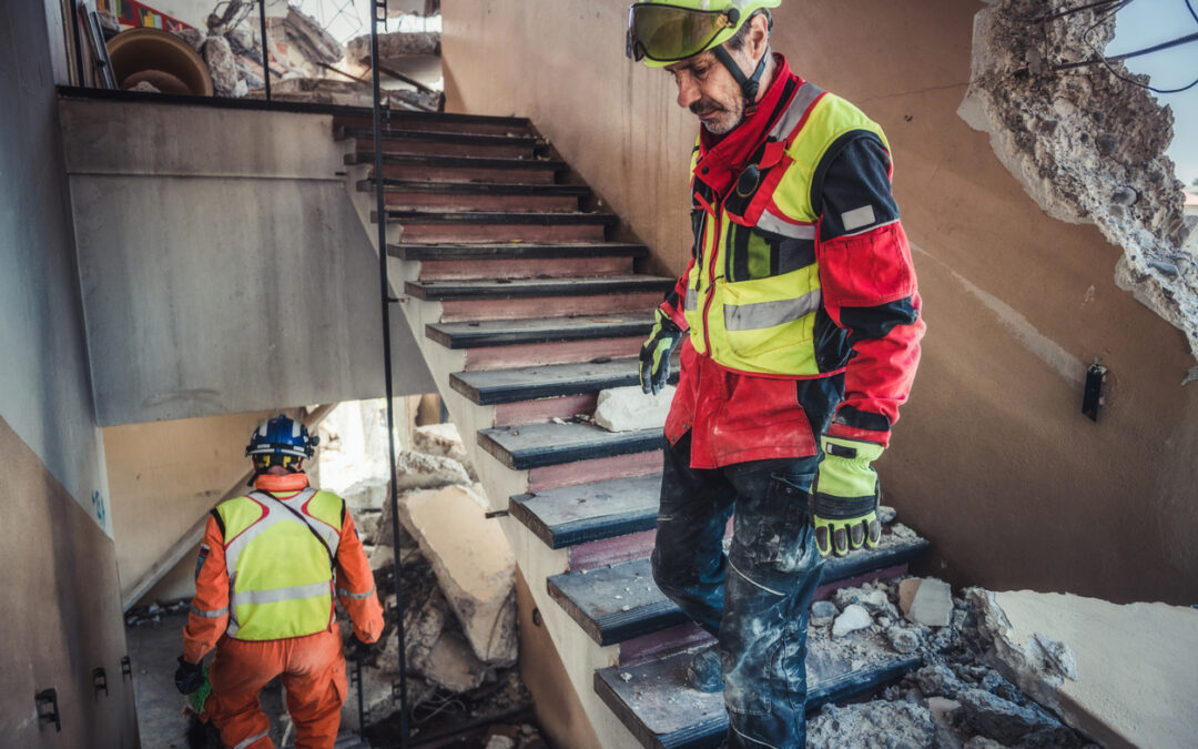 Disaster Recovery Consulting - a group of men in safety gear walking up stairs